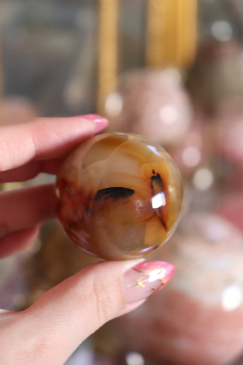Carnelian Sphere with “Ink-Spill” Inclusions – Mantra Minerals