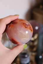 Load image into Gallery viewer, Cool-Toned Pink Carnelian Sphere with Quartz